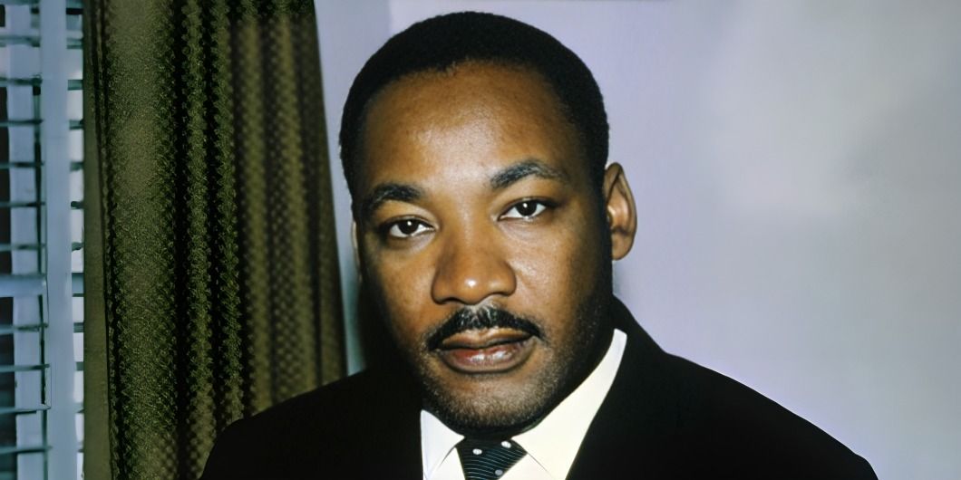 A black and white photo of Martin Luther King Jr. speaking to a crowd.
