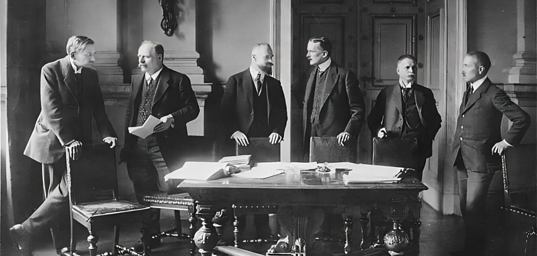 Many people sitting together at the Treaty of Versailles.