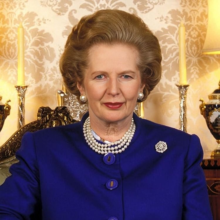Margaret Thatcher in a blue suit with pearls, sitting in an ornate setting.