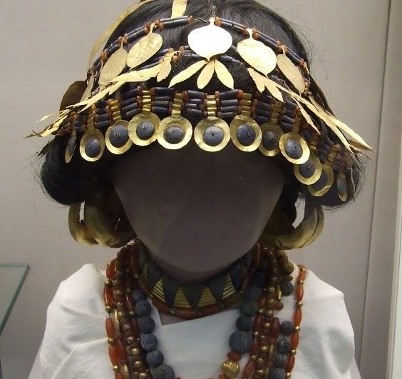 Ancient Mesopotamian ceremonial headdress made of gold and beads, showcasing intricate craftsmanship.