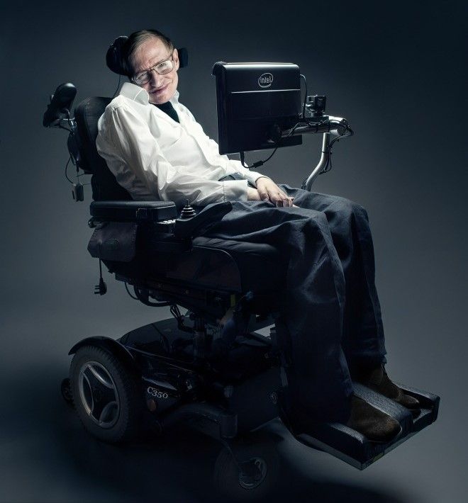 Stephen Hawking seated in his wheelchair against a dark background.