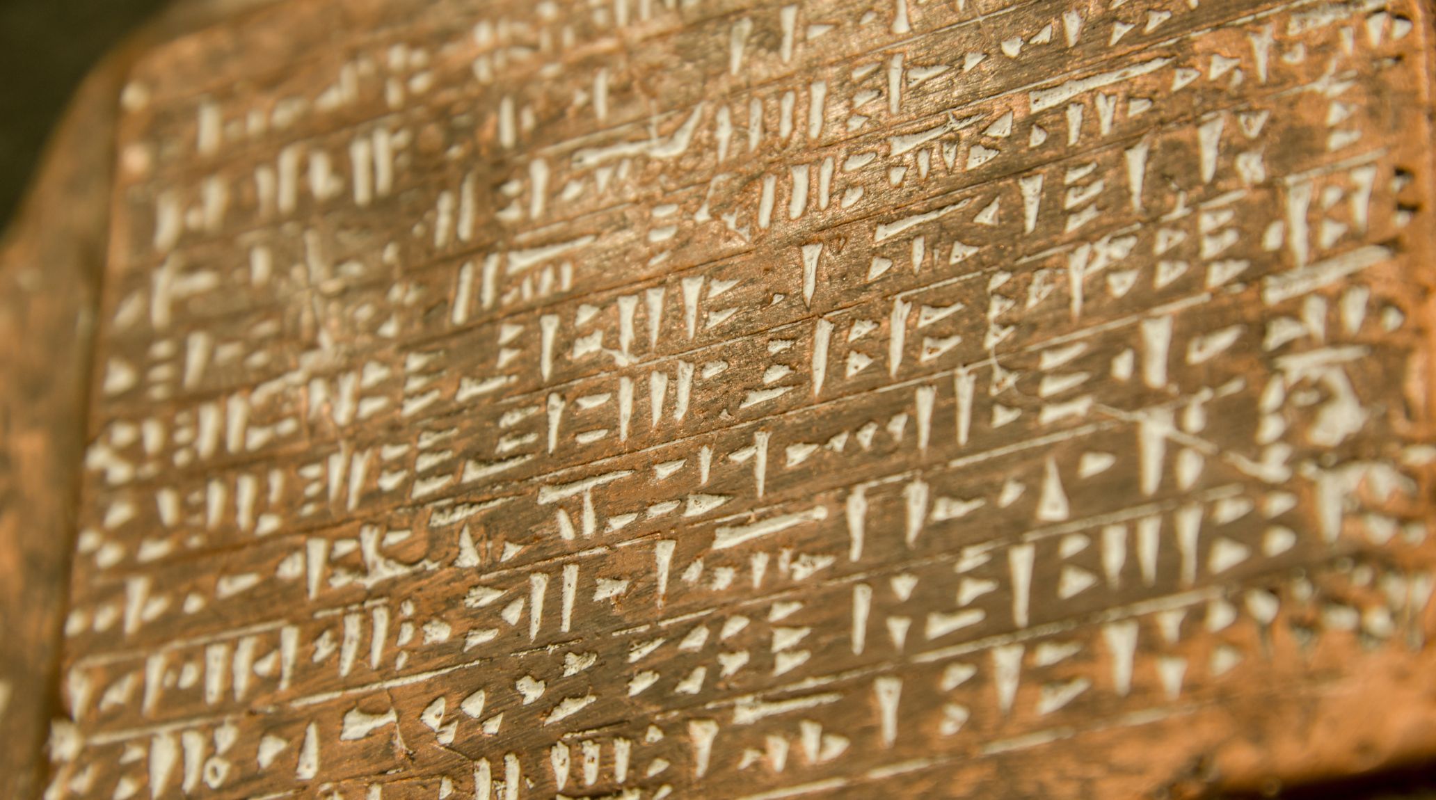 Ancient Mesopotamian cuneiform inscription on a stone wall.