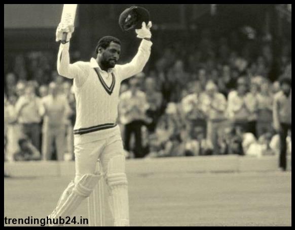 A man walking in a cricket feild, holding bat in his right hand.