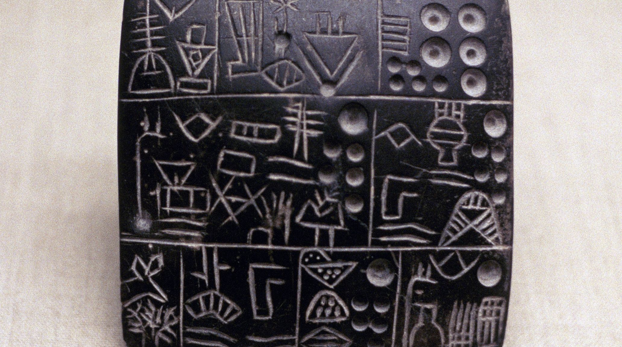 Ancient Mesopotamian clay tablet with Hammurabi's Code, cuneiform writing.