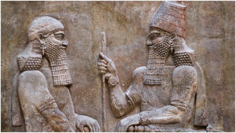 Relief of two Mesopotamian kings discussing legal reforms, symbolizing authority and justice in governance.