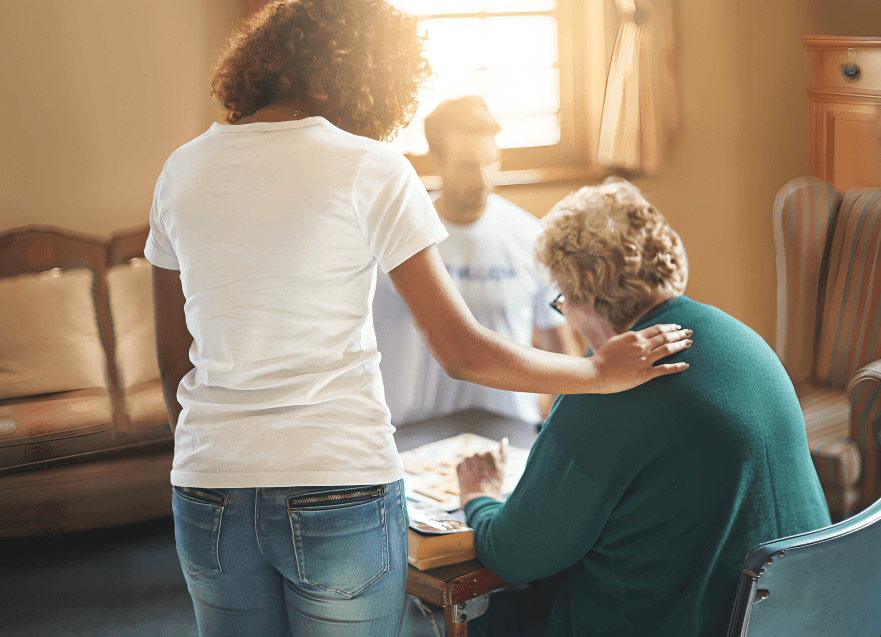 Person assisting an elderly person playing a game.