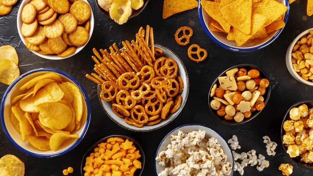 Assortment of savory snacks on a dark background.