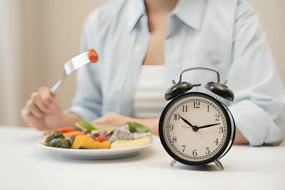 A woman with salad and clock for timed eating.