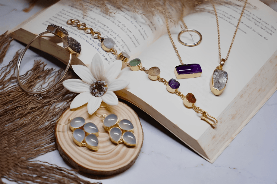 Natural stone jewelry displayed on an open book.