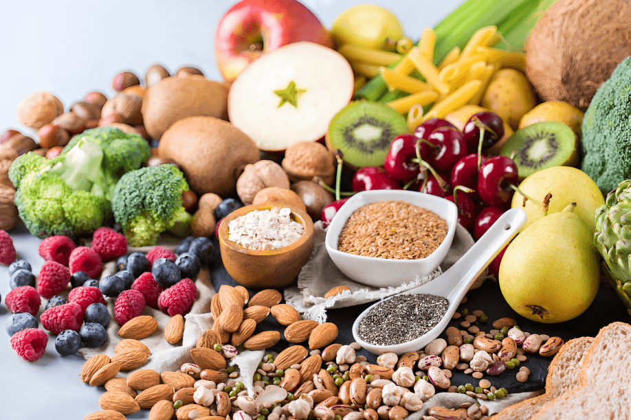 A variety of high-fiber foods: fruits, vegetables, nuts, and seeds.