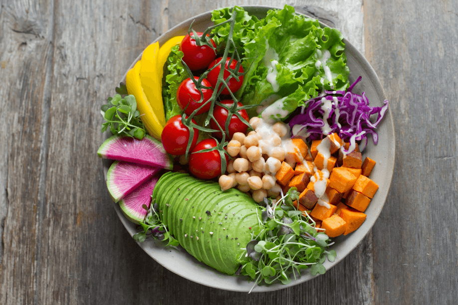 A vibrant salad bowl on a wooden surface.
