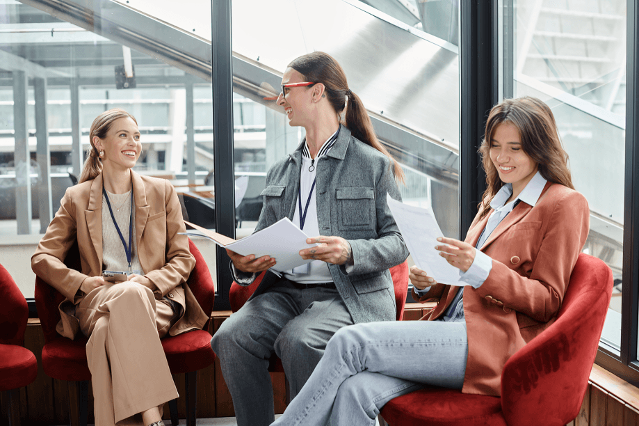 Three professionals, appearing to be female, in discussion.