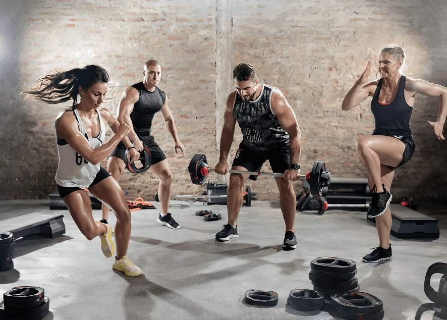 A diverse group of adults exercising together in a gym.