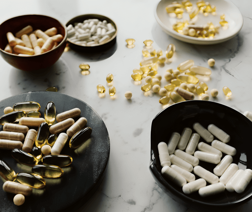 Various types of supplements and pills on a table.