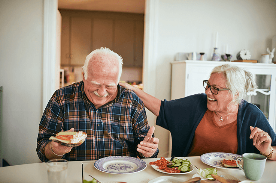 A happy senior couple enjoying a meal together.