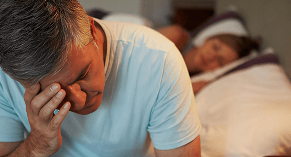 A senior woman with gray hair peacefully sleeping.