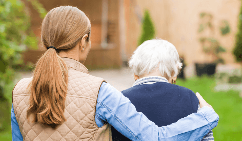 Younger person comforting an older person, walking away.