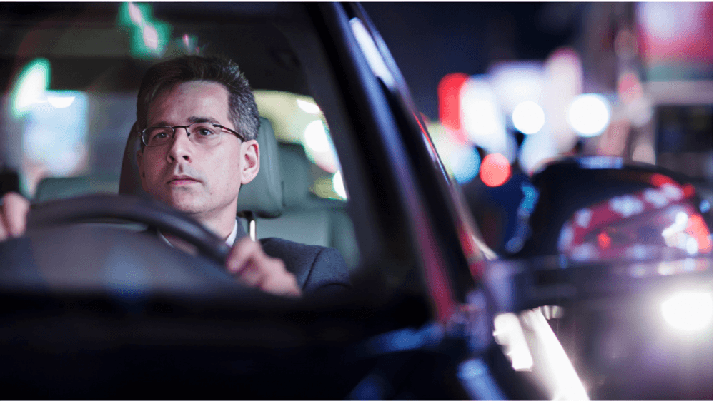 Man driving a car at night.