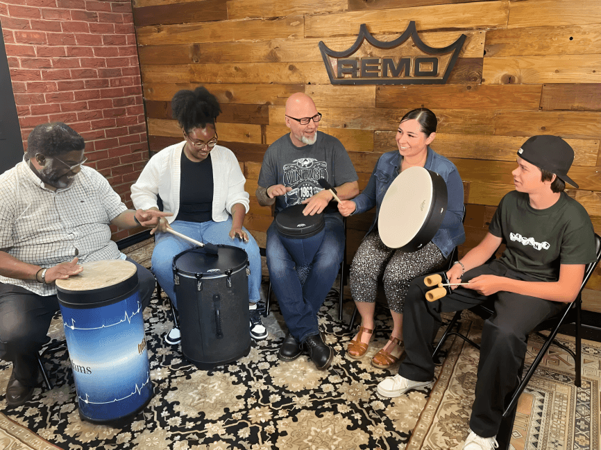 Diverse group playing hand drums and percussion.