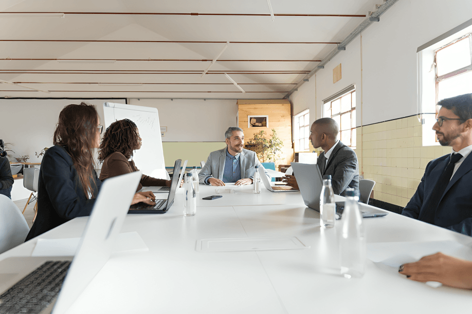 A diverse group of professionals in a meeting room.