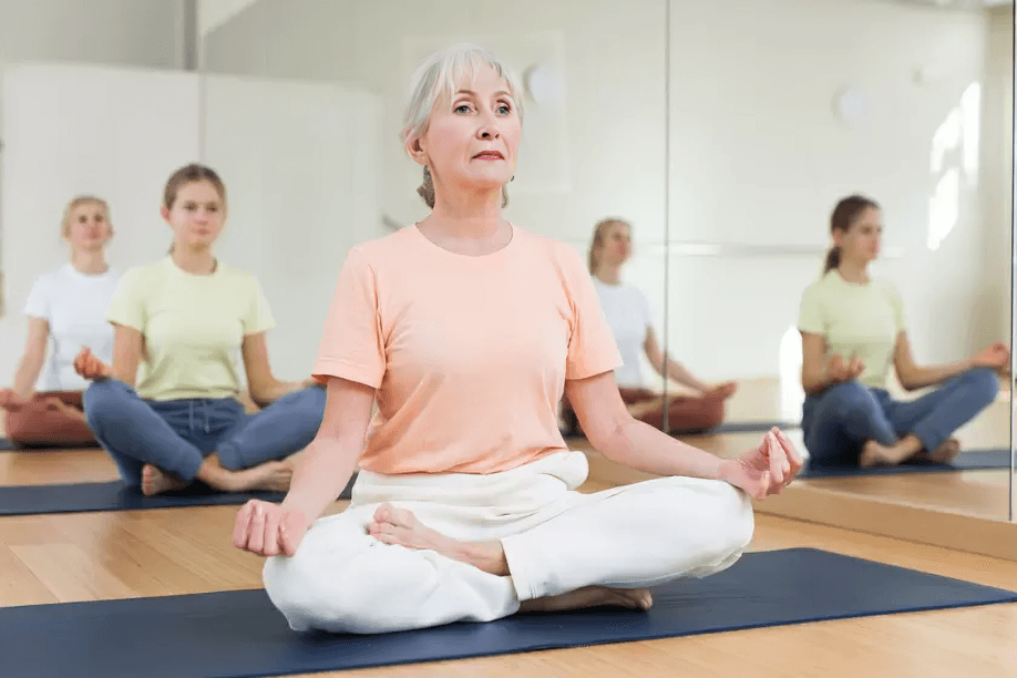 Group of women meditating in lotus position.