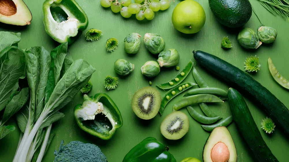 An assortment of fresh green fruits and vegetables.