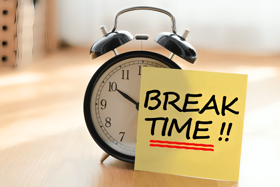 An alarm clock with a "BREAK TIME!!" sticky note.