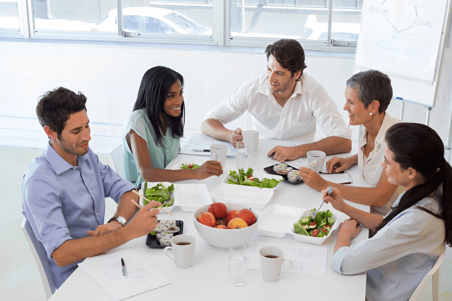 Five office workers having a healthy lunch meeting.