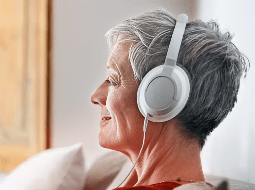 Close-up of older woman listening to headphones.