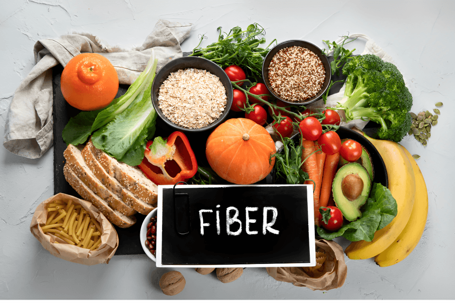 An assortment of high-fiber foods with a "FIBER" sign.