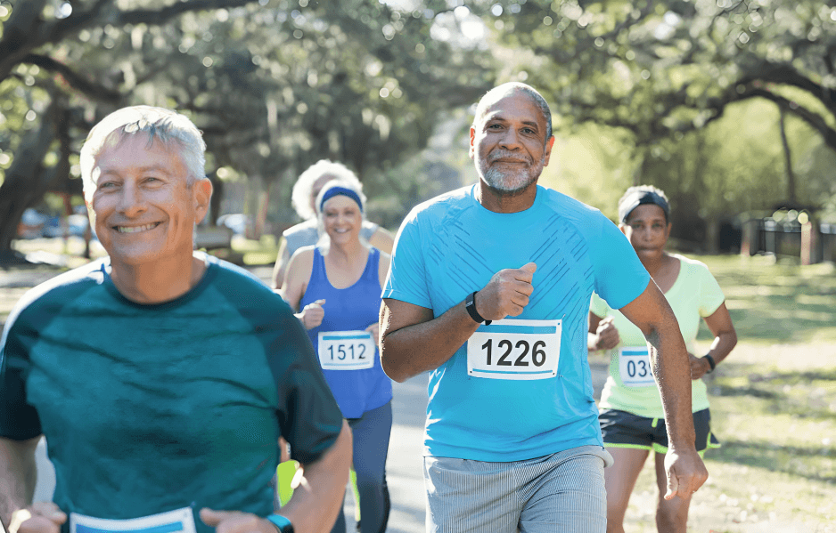 A group of smiling adults running a race.