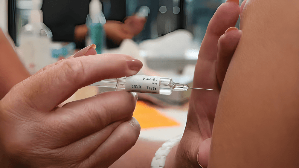 Close-up of a person receiving a vaccine injection.
