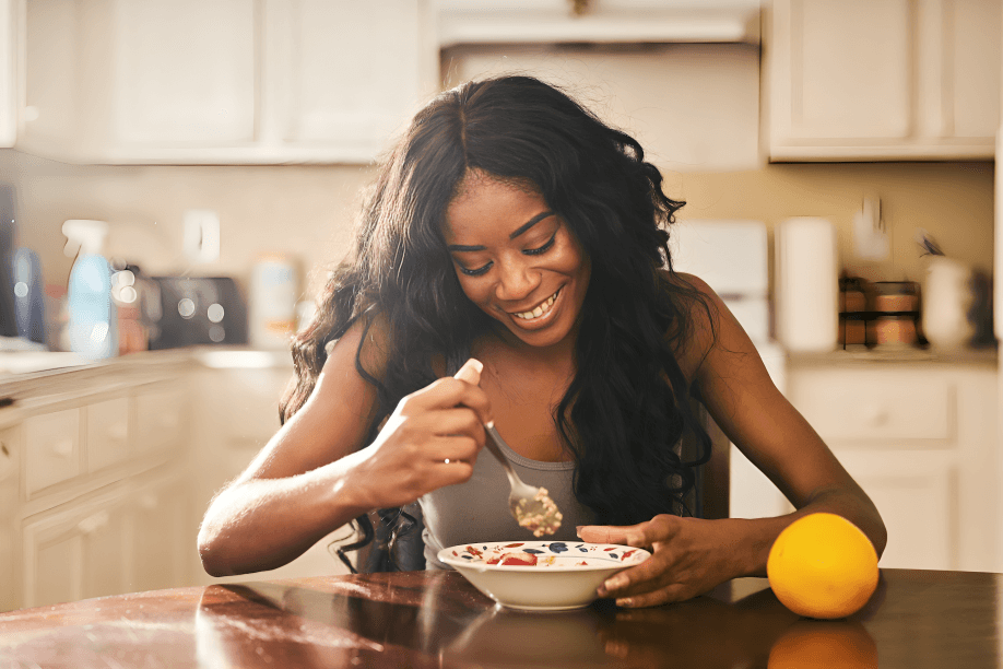 Person enjoying a healthy meal with a happy expression.