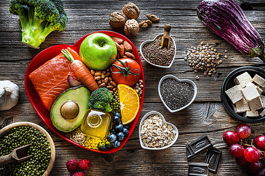 Heart-healthy food assortment on a wooden table.