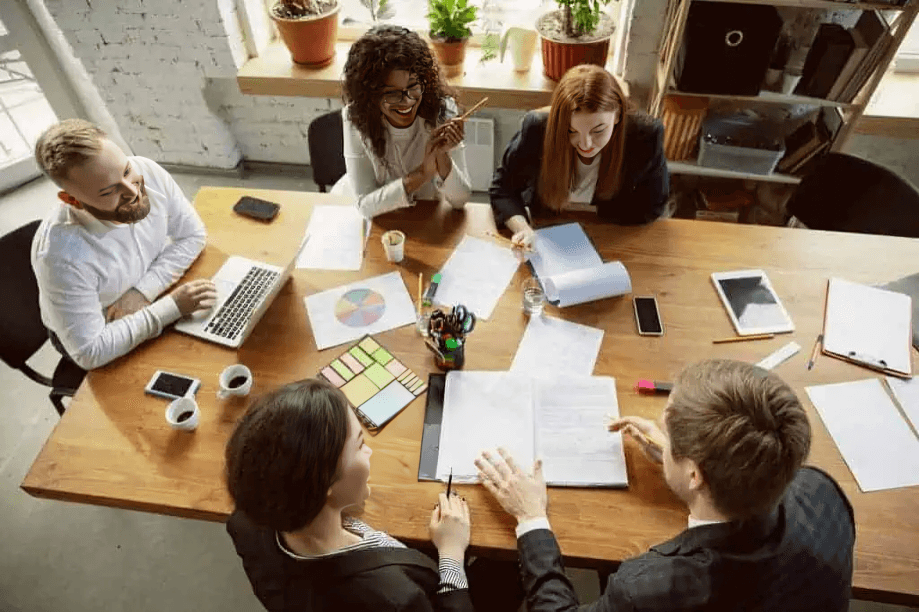 Overhead view of a diverse group in a lively meeting.