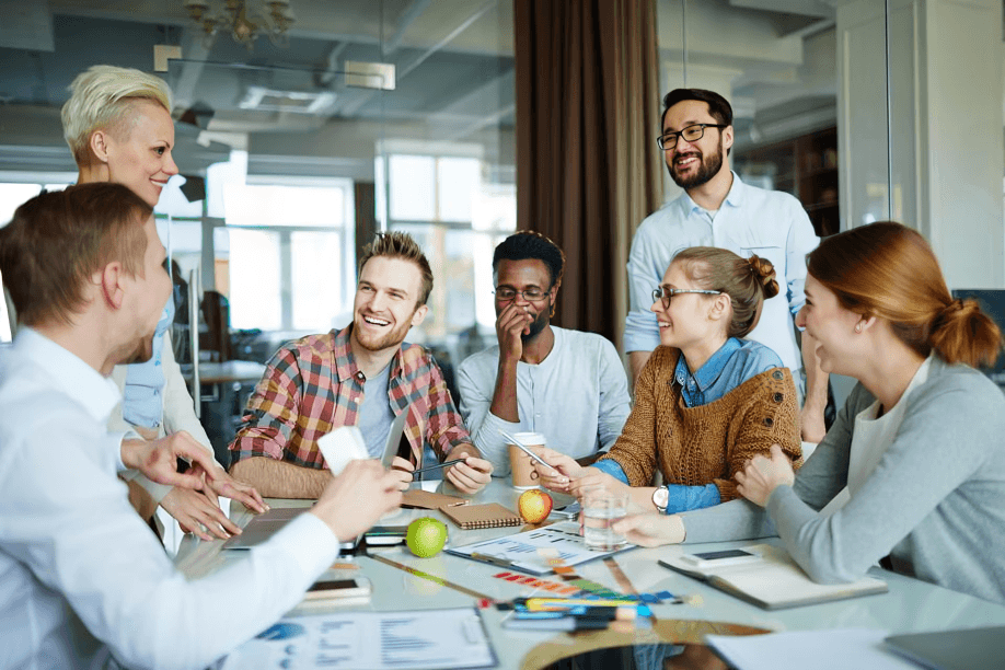 Diverse group of young professionals collaborating around a table.