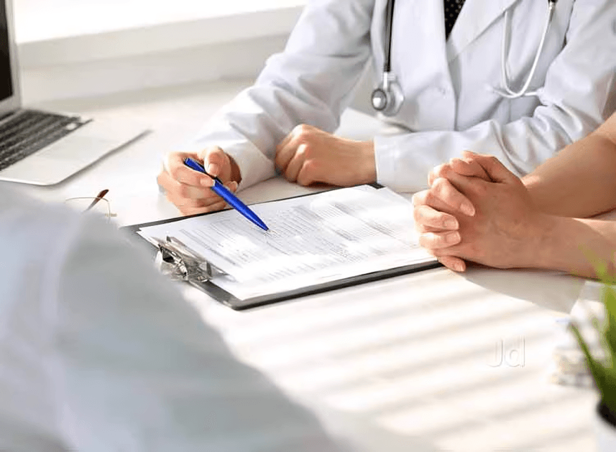 Doctor reviewing results with patient at a desk.