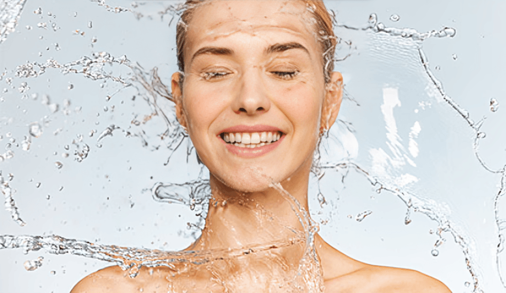 Woman with closed eyes enjoying splashing water.
