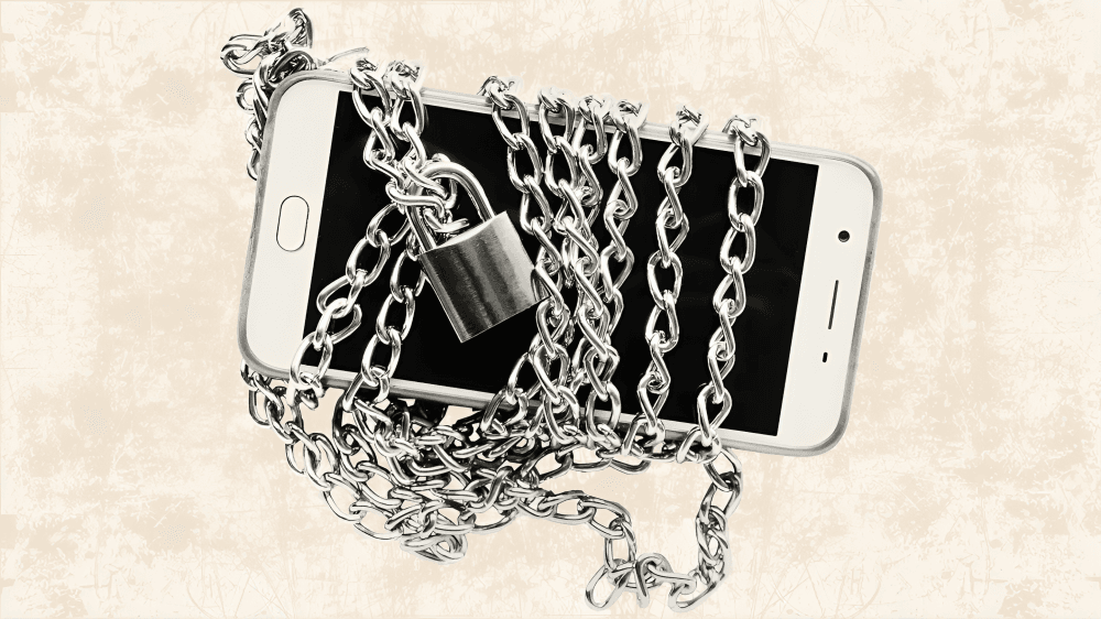 Phone wrapped in chains and a lock, digital detox.