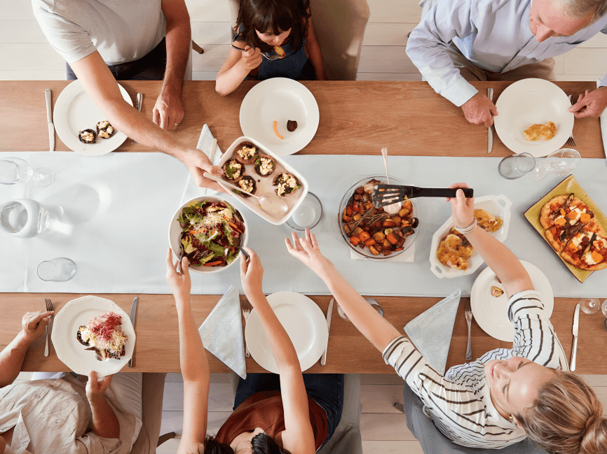 Family enjoying a meal together at a dining table.