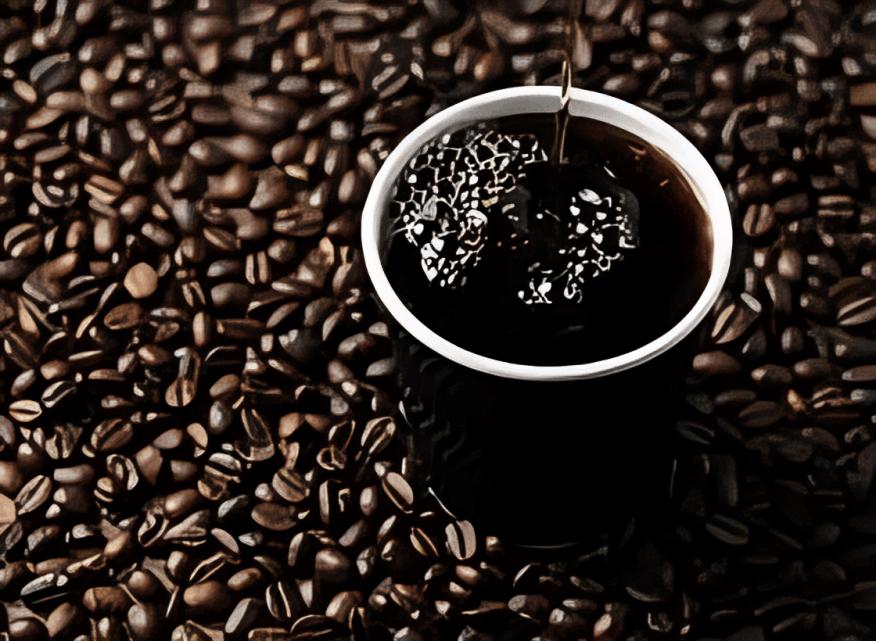 Dark coffee in a white cup amidst roasted beans.