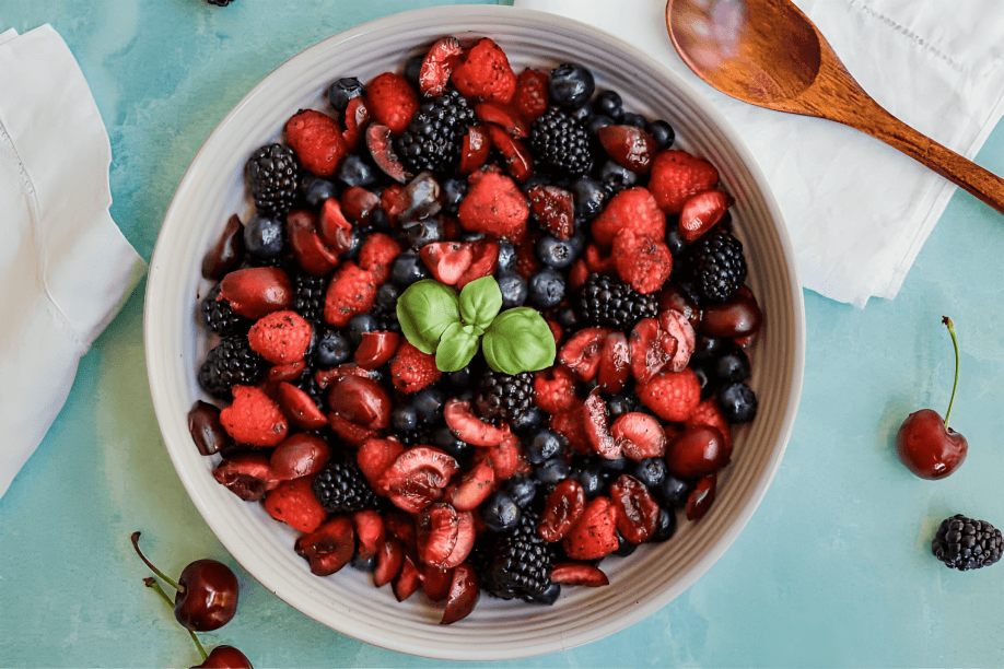 A colorful bowl of fresh berries and cherries.