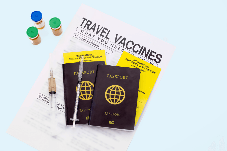 Passports, vaccines, and a syringe on a travel vaccination information sheet.
