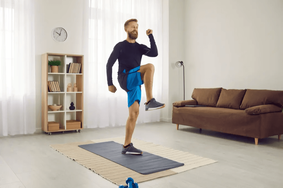 A man doing a cardio workout at home.