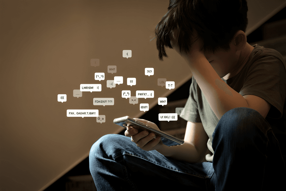 A distressed young person receiving negative messages on their phone.