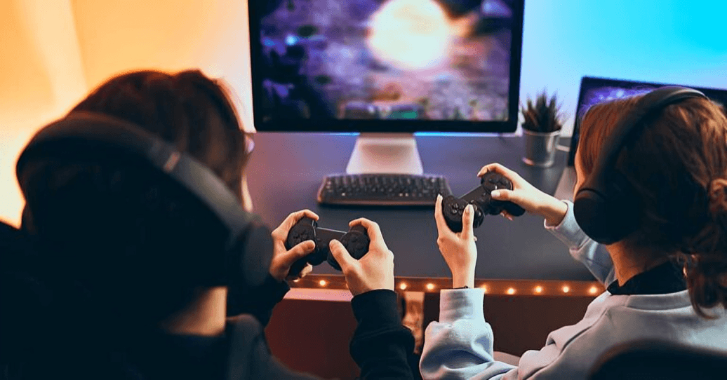 Two people playing video games with controllers and headsets.