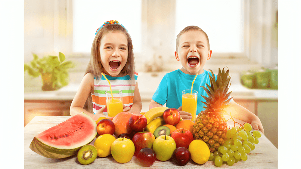 Two cheerful children with fruit and juice laughing.