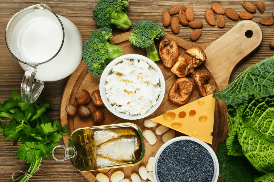 Various calcium-rich foods on a wooden table.