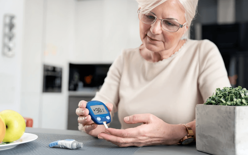 An older woman checks her blood sugar level.