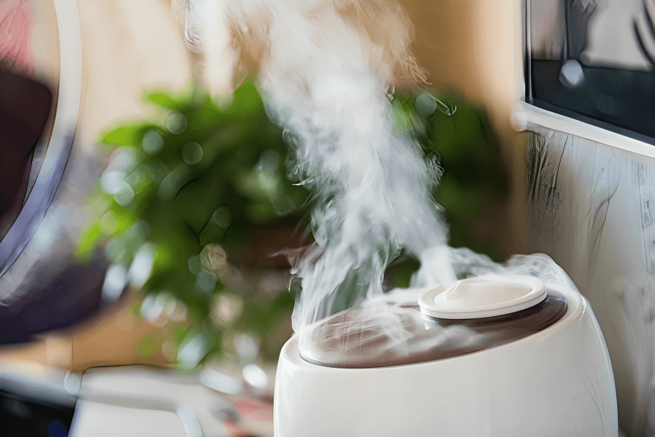 A white humidifier emitting steam in a room setting.